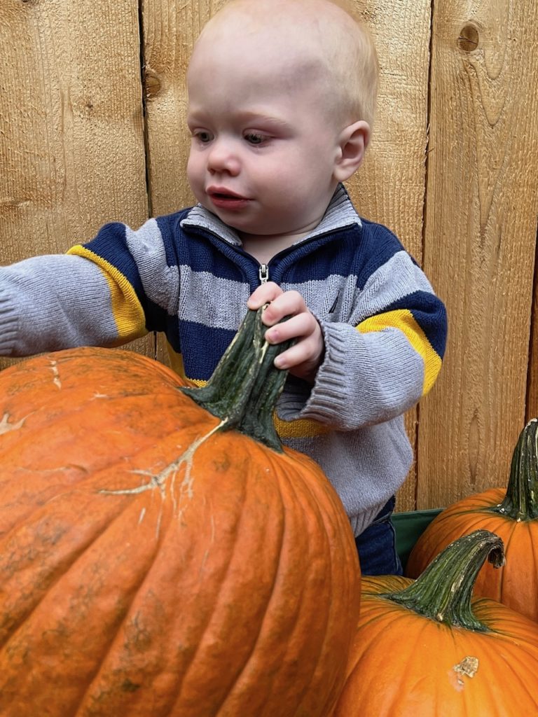 Baby with pumpkins